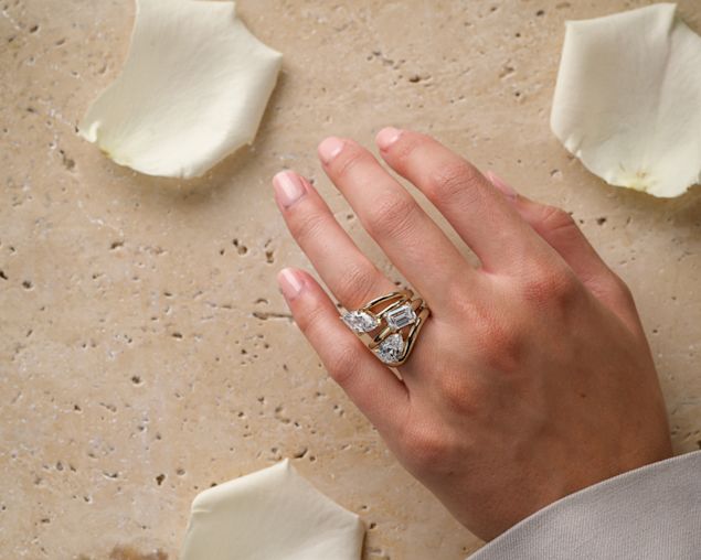woman wearing yellow gold rings, earrings and necklace